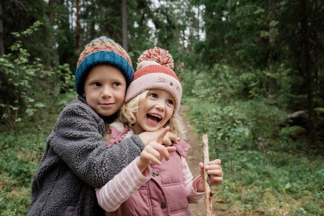 brother hugging his sister laughing whilst walking through the forest Sweden, Stockholm County, Norrtälje CR_RABE191001A-200289-01