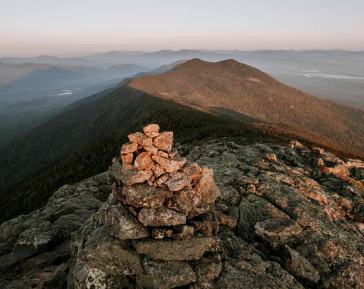 A stone cairn near the summit of a mountain in Maine at sunset United States, Maine, Carrabassett Valley CR_SSNF191022-170072-01
