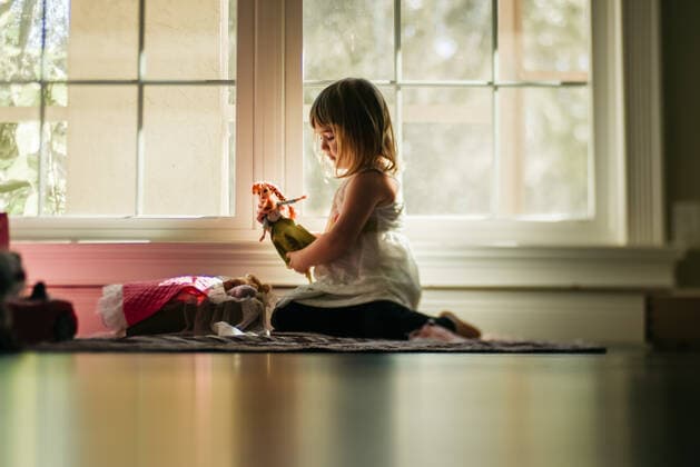 young girl playing dolls by window United States, Florida, Longwood ,editorial use only R_CAPO191022-60840-01