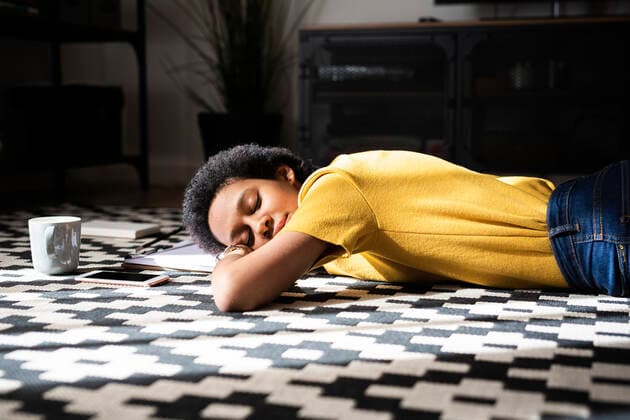 Young woman lying on the floor at home with closed eyes model released Symbolfoto property released  GIOF07783