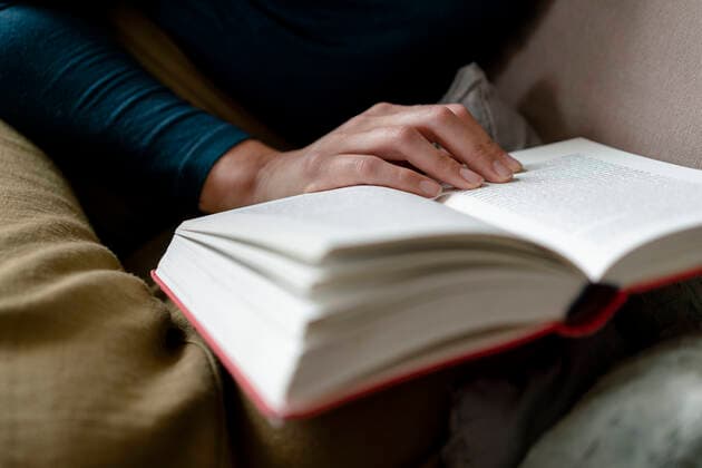 Woman reading novel, close-up model released Symbolfoto property released  KNSF06840