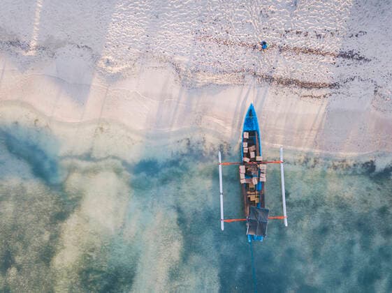 Drone shot of boxes in outrigger at Gili-Air Island, Bali, Indonesia  KNTF03446