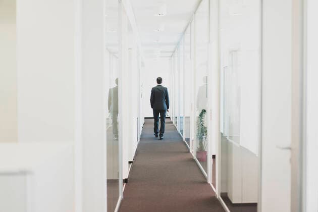 Rear view of businessman walking down office corridor model released Symbolfoto property released  MOEF02560