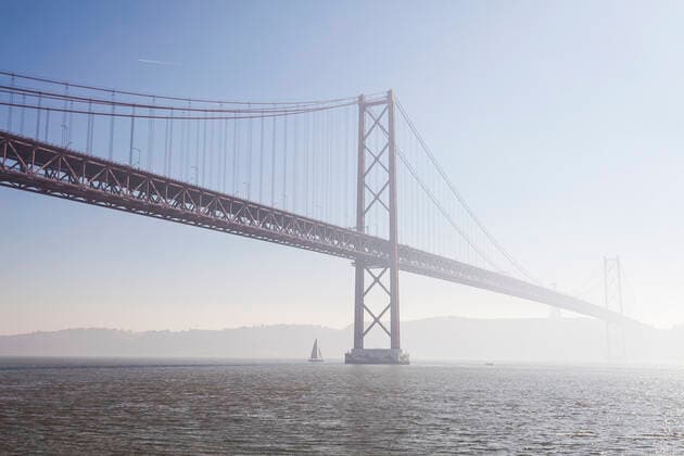 April 25th Bridge over Tagus river against sky, Lisbon, Portugal  XCF00196