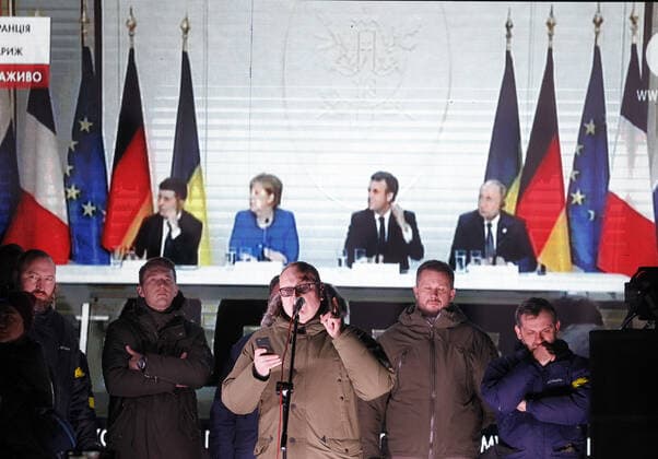 December 10, 2019, Kiev, Ukraine: Ukrainians watch a joint news conference following the Normandy Four leaders summit, Volodymyr Zelensky, Vladimir Putin, Angela Merkel and Emmanuel Macron, outside the Presidential Office in Kiev..A Normandy Format summit with the participation of leaders of Ukraine, Russia, France and Germany regarding the conflicts in eastern Ukraine was held in Paris. Kiev Ukraine - ZUMAs197 20191210_zaa_s197_018 Copyright: xPavloxGoncharx