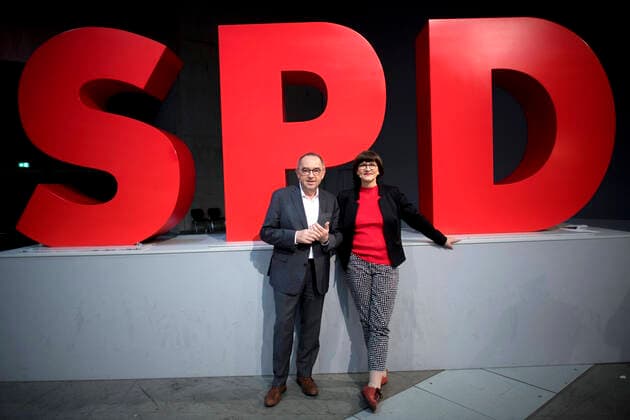 Walter-Borjans, Esken, SPD DEU, Deutschland, Germany, Berlin, 08.12.2019 Norbert Walter-Borjans und Saskia Esken (v.l.n.r.), die neuen Parteivorsitzende der SPD, vor dem Logo auf dem Parteitag der SPD unter dem Motto In Die Neue Zeit in Berlin. Portrait Norbert Walter-Borjans and Saskia Esken (f.l.t.r.), the new elected co-leaders of the German Social Democrats SPD, in front of the Logo at the SPD federal party congress on December 8, 2019 in Berlin, Germany. SPD members nationwide voted for the pair and delegates are expected to confirm their election. Their election has raised concerns that, because the two pushed a markedly left-wing platform, the SPD might break from its governing coalition