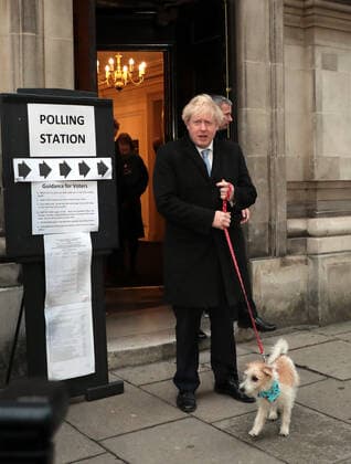 British Prime Minister Boris Johnson and his dog Dilyn leaves a Westminster polling station after casting his vote on Thursday, December 12, 2019. Mr Johnson is seeking a majority in the General Election on December 12th to enable the government to get Brexit passed.  LON2019121201 HUGOxPHILPOTT