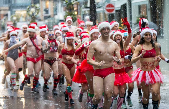 (191214) -- TORONTO, Dec. 14, 2019 -- Participants take part in the 2019 Toronto Santa Speedo Run in Toronto, Canada, Dec. 14, 2019. Dozens of participants dressed in bathing suits and Santa Claus hats took part in this annual event on Saturday to raise money for sick kids. (Photo by Xinhua) CANADA-TORONTO-SANTA SPEEDO RUN ZouxZheng 