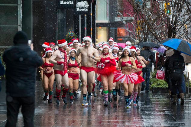 (191214) -- TORONTO, Dec. 14, 2019 -- Participants take part in the 2019 Toronto Santa Speedo Run in Toronto, Canada, Dec. 14, 2019. Dozens of participants dressed in bathing suits and Santa Claus hats took part in this annual event on Saturday to raise money for sick kids. (Photo by Xinhua) CANADA-TORONTO-SANTA SPEEDO RUN ZouxZheng 