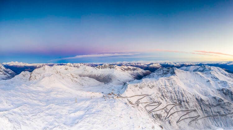 Pano by drone of sunrise over the narrow bends of Stelvio Pass mountain road covered with snow, Bormio, Valtellina, Lombardy, Italy, Europe Copyright: RobertoxMoiola 1179-4091