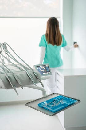 Rear view of female dentist working in dental clinic model released Symbolfoto property released  DLTSF00362