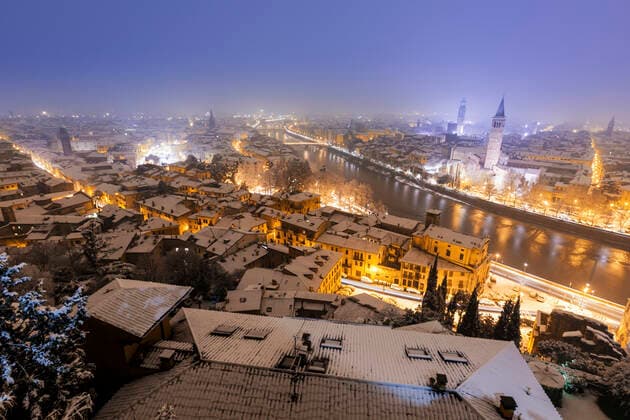Italy, Verona, High angle view of city illuminated at night in Winter  GIOF07601