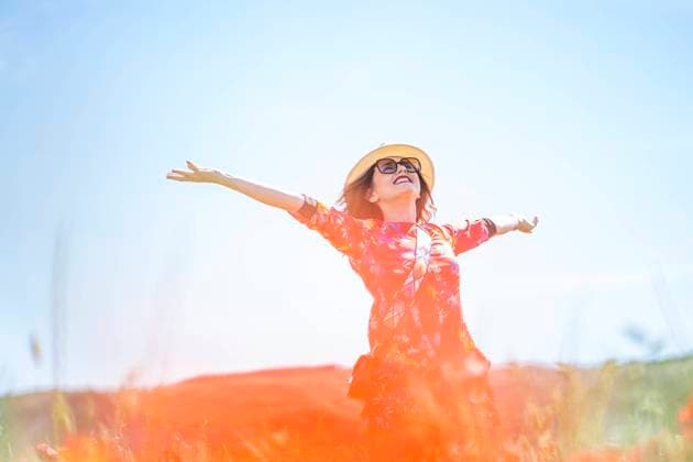 Creative Highlights Symbolfotos Happy woman on a meadow looking up to the sky model released Symbolfoto  OCMF00943