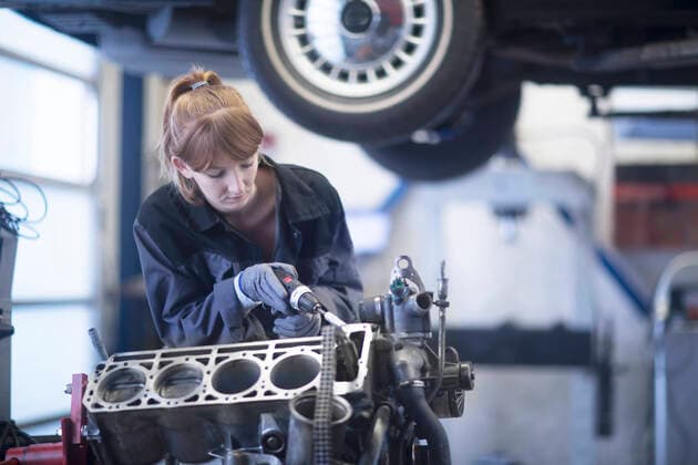 Female car mechanic fixing car in repair garage model released Symbolfoto property released  SGF02530
