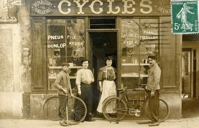 CYCLES annees 1900 Devanture d un magasin de cycles. Photographie anonyme pour une carte postale vers 1909. Credit : Collection IM KHARBINE-TAPABOR *** CYCLES years 1900 Front of a bicycle shop Anonymous photograph for a postcard around 1909 Credit Collection IM KHARBINE TAPABOR  KH178402