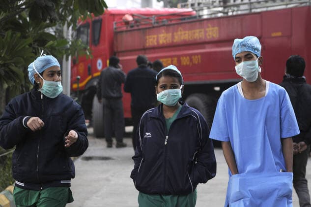 NOIDA, INDIA - JANUARY 9: Hospital staff near a fire services vehicle after a fire incident in the basement of ESIC Hospital at Sector 24 on January 9, 2020 in Noida, India. (Photo by Sunil Ghosh Hindustan Times) Fire At Noida ESIC Hospital