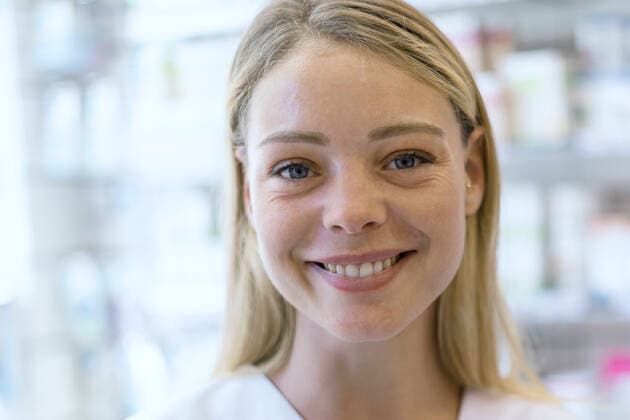 Portrait of smiling young woman standing in pharmacy Copyright: FrédéricxCirou B65099139