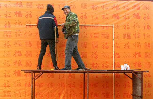 Chinese workers decorate a park for the upcoming Chinese New Year celebrating the Year of the Rat in Beijing on Saturday, January 18, 2020. The Year of the Rat is traditionally the most unfortunate, laden with bad omens and mishaps - this as China s economic growth hits a three-decade low, a new coronavirus outbreak, a trade war and and pork output plunging to a 16-year low.  PEK2020011802 STEPHENxSHAVER