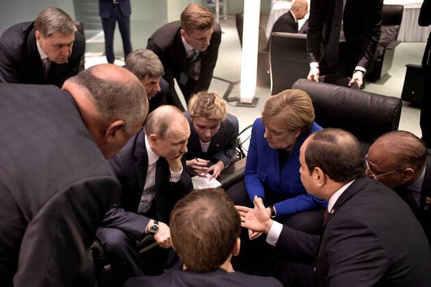 BERLIN, GERMANY - JANUARY 19, 2020: Russia s President Vladimir Putin (CL midground sitting) and Germany s Chancellor Angela Merkel (CR midground sitting) talk during a meeting on the sidelines of an international summit on Libya; the summit is to discuss efforts to achieve peace and reconciliation between Libya s government and General Haftar; right: the Russian president s adviser Yuri Ushakov. Alexei Nikolsky Russian Presidential Press and Information Office TASS  TS0CAC83