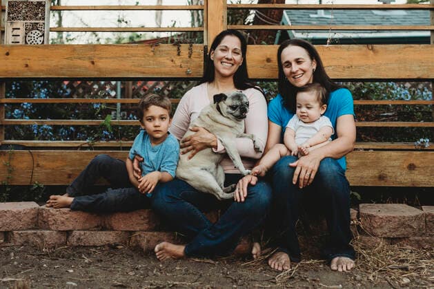 Happy barefoot family with two moms holding boy, baby and Pug La Mesa, CA, USA CR_KESM191114A-213458-01