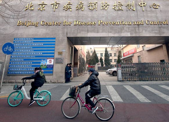 Chinese security guards stand outside the capital s center for disease control, prevention and research in central Beijing on Tuesday, January 21, 2020. Health authorities in China reported the country s fourth death from a new type of coronavirus, as the country braces for the Lunar New Year travel boom amid concerns over a possible outbreak similar to that of the SARS virus in the early 2000s.  PEK2020012105 STEPHENxSHAVER