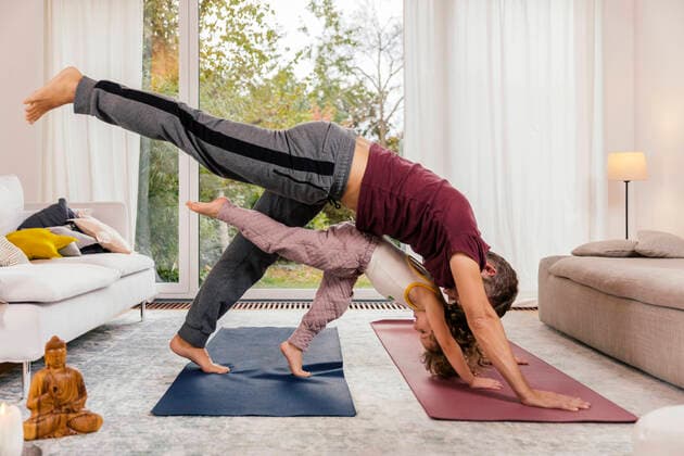 Father and daughter doing yoga together at home model released Symbolfoto property released  MFF05015