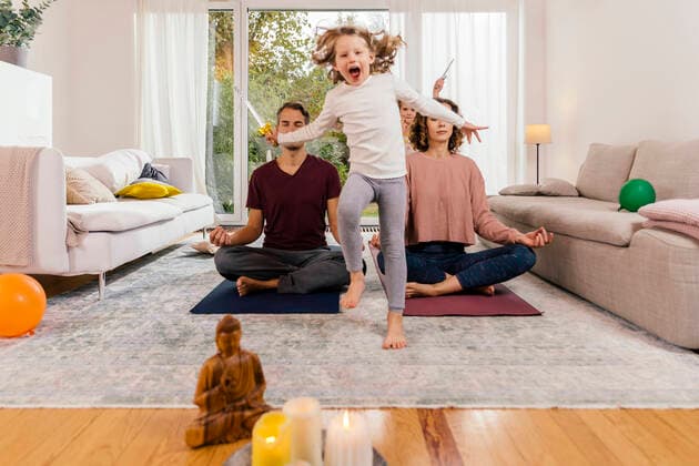 Exuberant girl with parents meditating at home model released Symbolfoto property released  MFF05021