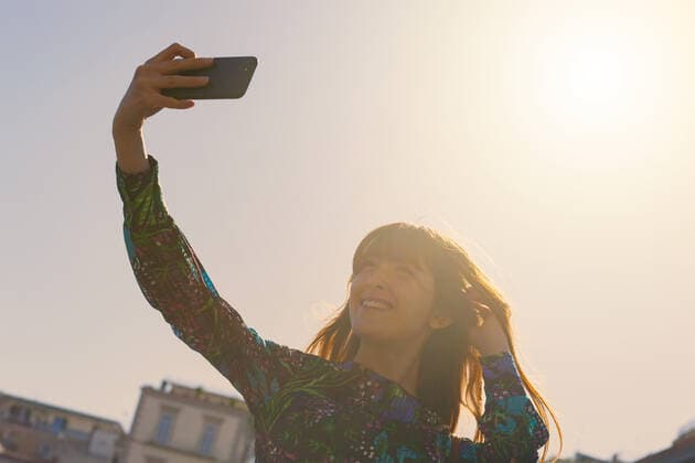 Beautiful young woman with red hair and freckles takes a selfie in Piazza Pebliscito in Naples *** Beautiful young woman with red hair and freckles takes a selfie in Piazza Pebliscito in Naples  1085308069