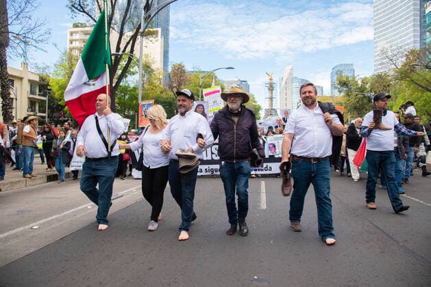 January 26, 2020, Mexico City, Mexico: Javier Sicilia, with a hat and leading members of the LeBaron family, walks in front of the peaceful march that demands the government of President Lopez Obrador to stop the violence. They took away a shoe a a sign of solidarity Mexico City Mexico  - ZUMA 20200126_mda_qp1_587 Copyright: xHectorxAdolfoxQuintanarxPerezx