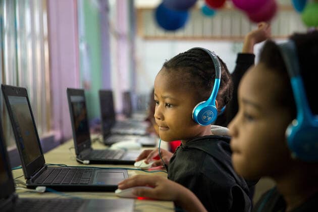 School girl child sitting and concentrating at a laptop  Copyright: xGreatstockx O-066-0567G