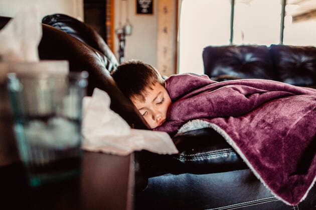 Young boy asleep on couch feeling ill De Motte, IN, United States CR_CHSI200103-265605-01