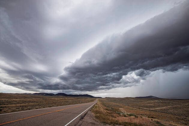 A thunderstorm approaches a rural road in the Montana plains Jackson, MT, United States CR_SSNF200102A-253962-01