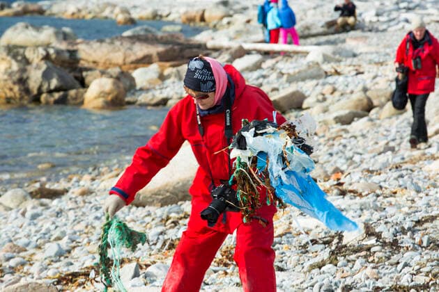Tourist collect plastic rubbish on a remote beach in Northern Svalbard, only about 600 miles from the North Pole. The plastic has been washed ashore by ocean currents. SvalbarÃ°shreppur, Iceland ,editorial use only CR_OQMH191212B-262534-01