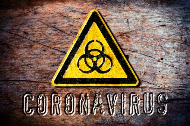 FOTOMONTAGE, BiogefÃ¤hrdungsschild und Schriftzug Coronavirus