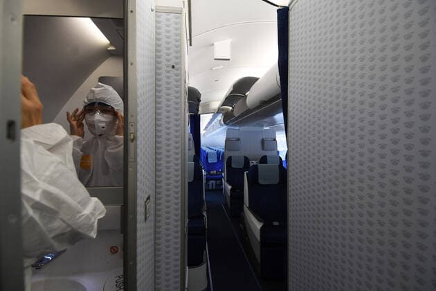 (200207) -- BEIJING, Feb. 7, 2020 -- A crew member of a charter flight makes preparations at Singapore Changi Airport in Singapore, Feb. 5, 2020. China dispatched a charter flight Wednesday to fly 147 stranded Hubei residents home from Singapore following the novel coronavirus outbreak. (Photo by Xinhua) XINHUA PHOTOS OF THE DAY ThenxChihxWey 