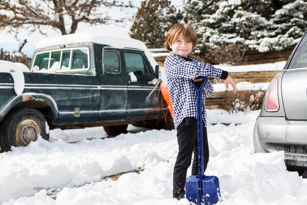A six year old boy shoveling snow in driveway A six year old boy shoveling snow in driveway  60186