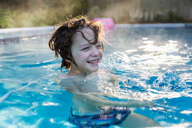 A six year old boy swimming in a warm pool. A six year old boy swimming in a warm pool. ,St Simon s Island  61007