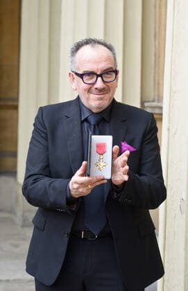 . 14 02 2020. London, United Kingdom. Declan Patrick MacManus, better known by his stage name Elvis Costello, with his OBE for Services to Music after an Investiture at Buckingham Palace in London.  xPoolx xi-Imagesx IIM-20779-0002