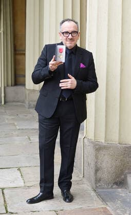 . 14 02 2020. London, United Kingdom. Declan Patrick MacManus, better known by his stage name Elvis Costello, with his OBE for Services to Music after an Investiture at Buckingham Palace in London.  xPoolx xi-Imagesx IIM-20779-0006