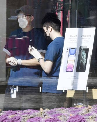New coronavirus Employees at one of the Apple Inc. stores in Beijing wear masks on Feb. 18, 2020, amid the spread of a new coronavirus. 