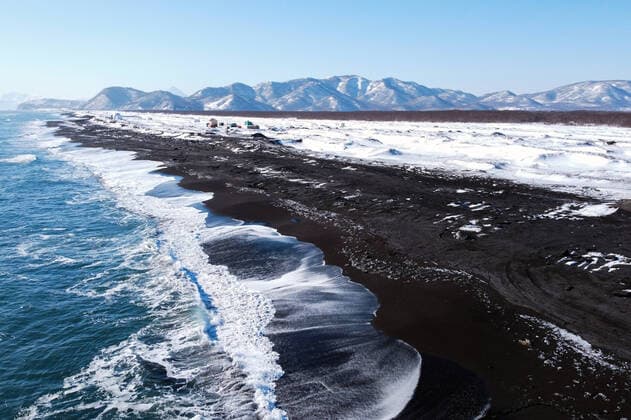 KAMCHATKA TERRITORY, RUSSIA - FEBRUARY 19, 2020: A view of the Khalaktyrsky black-sand beach on Russia s Pacific Coast, one of Kamchatka s most popular beaches. Yuri Smityuk TASS  TS0CEEFD