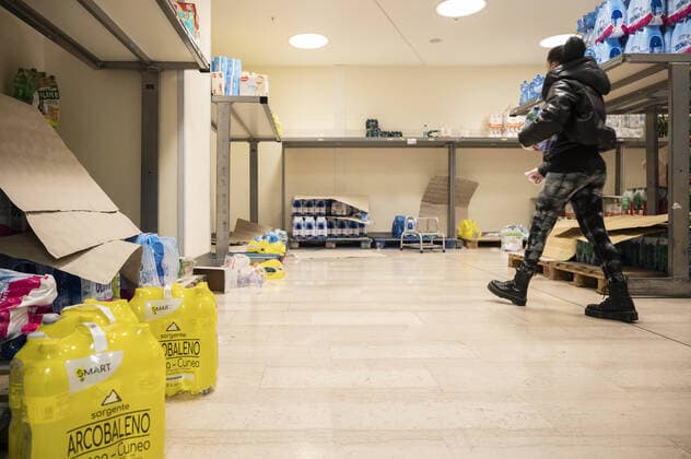 February 23, 2020, Milan, Italy: A woman walks in an empty supermarket..Precautionary measures, as wearing masks, had been taken by citizens and tourists in Milan, for dealing with the fear of being infected by Coronavirus (COVID -19), as more than one hundred confirmed cases had been discovered in north Italy and three old people died. According to a regional decree, many activities (educational, cultural, museum tours) will be suspended until 1st or 2nd March; thus, people reacted with a massive rush to buy water, food supply and soaps. Milan Italy - ZUMAs197 20200223_zaa_s197_250 Copyright: xValeriaxFerrarox