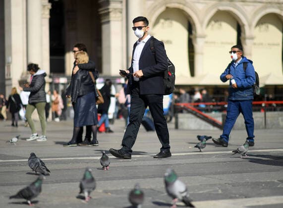 (200224) -- MILAN, Feb. 24, 2020 (Xinhua) -- People wear masks as they walk in Milan, Italy, on Feb. 24, 2020. Six people have died and 222 have tested positive for the novel coronavirus (COVID-19) nationwide in Italy, Angelo Borrelli, chief of Civil Protection Department and Extraordinary Commissioner for the Coronavirus Emergency, told a press conference at 6 p.m. local time on Monday. (Photo by Daniele Mascolo Xinhua) ITALY-MILAN-COVID-19-CONFIRMED CASES-RISE 
