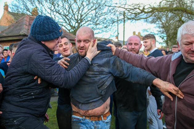 . 25 02 2020. Sedgefield, United Kingdom. The traditional Shrove Tuesday Ball Game in Sedgefield. Where a small, leather ball is chased around the village for hours. Pictured is the winner.  xTomxBanksx xi-Imagesx IIM-20824-0060