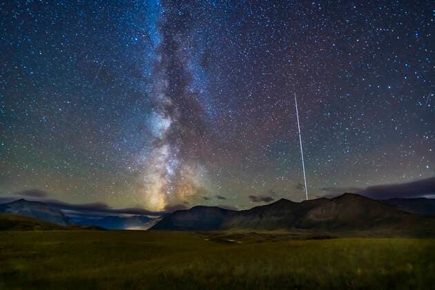 IMAGO Nature: Unsere Erde, Naturschutz, Naturschutzgebiete in Nordamerika The northern summer Milky Way setting over the mountains of Waterton Lakes National Park, Alberta, Canada, with the Space Station rising at right, then fading into sunset, in a trail from the series of long exposures. This is from the Bison Compound viewpoint looking south and southwest, on September 21, 2019, in frames taken as part of a time-lapse. This is a stack of 8 images for the ground to smooth noise, one image from the set for the stars to minimize trailing, and a stack of 6 images masked to reveal just the ISS trail. The trail fades to deep red as the ISS travels into the Earth™s shadow as it rose here and experienced sunset at their altitude. A mild Orton glow effect added with Luminar Flex. Each exposure in the set was 30 seconds at ISO 4000 and f 2 with the Venus Optics 15mm lens and Sony a7III. Part of a 360-frame time Copyright: xAlanxDyerx xVWPicsx ADY-2019-224