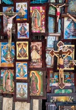 Religious paintings and Christ on the cross figurines for sale in plaza in front of Our Lady of San Juan de los Lagos church in the town of San Juan de los Lagos, Jalisco, Mexico. Guadalajara Jalisco Mexico Copyright: xGregxVaughnx GVA-0143