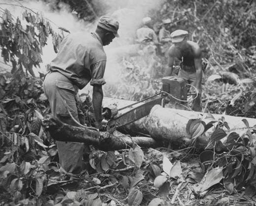African American combat engineers use a motor-driven saw to remove trees on a trail on Bougainville. July 17, 1944. World War 2. (BSLOC_2014_10_229) For usage credit please use; PUBLICATIONXNOTxINxCANxCHNxFRAxITAxJPNxNORxPOLxRUSxESPxUKxUSA Copyright: xCourtesyxEverettxCollectionx HISL037 EC923