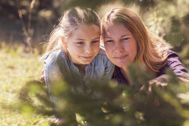 Mother and daughter watching insects on a tree model released Symbolfoto  DHEF00110