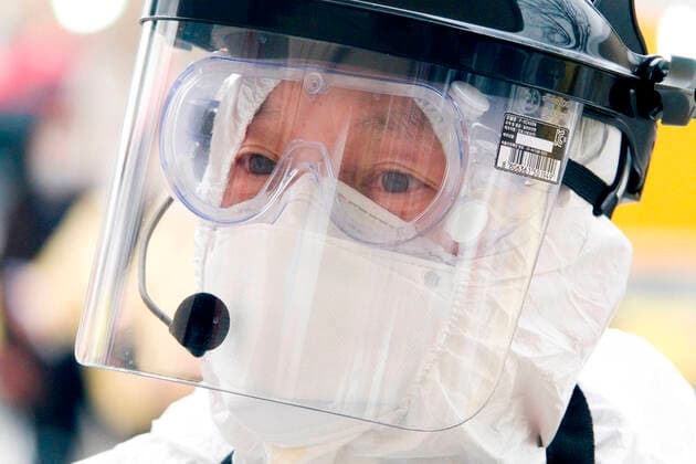 Drive-thru clinic testing of the COVID-19, Feb 28, 2020 : A medical staff wears protective suit at a drive-thru clinic testing of the COVID-19 in Goyang, north of Seoul, South Korea. South Korea s local governments have introduced testing facilities where medical staff take samples from people in cars who have suspected symptoms of COVID-19. Drivers do not have to get out of their cars and they open a window to be checked for fever or have samples taken by medical staff in protective suits. Health authorities said the entire process takes about 10 minutes. South Korea reported 571 new cases of the coronavirus on Friday to bring the total number of infections to 2,337 as the country worked actively to counter the spreading virus with extensive testing, local media reported.  (123341494)