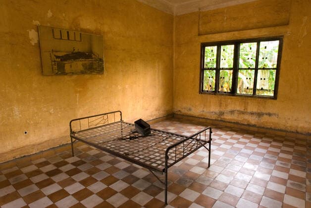 Museum-School Tuol Sleng. This is a secondary school that Pol Pot turned into a security prison known as S-21. Prior to 1975 Toul Sleng was a high school but under the Khmer Rouge it was used as a torture facility. The building now serves as a museum and a memorial. Photos of some of the victims as well as paintings by a survivor hang on the walls. The complex has been preserved as the KR left it. Tuol Sleng Museum was originally a high school and later used as a security prison (S-21) by the Khmer Rouge regime.The classrooms were converted into tiny prison cells and torture chambers.Prisoners were repeatedly tortured with beatings,electric shock and hanging upside down then dropped into water barrels.The lower floors are filled with hundreds of photos of victims .From here many of the prisoners were loaded onto trucks and sent to the ki Copyright: xSergixReboredox REB-1653